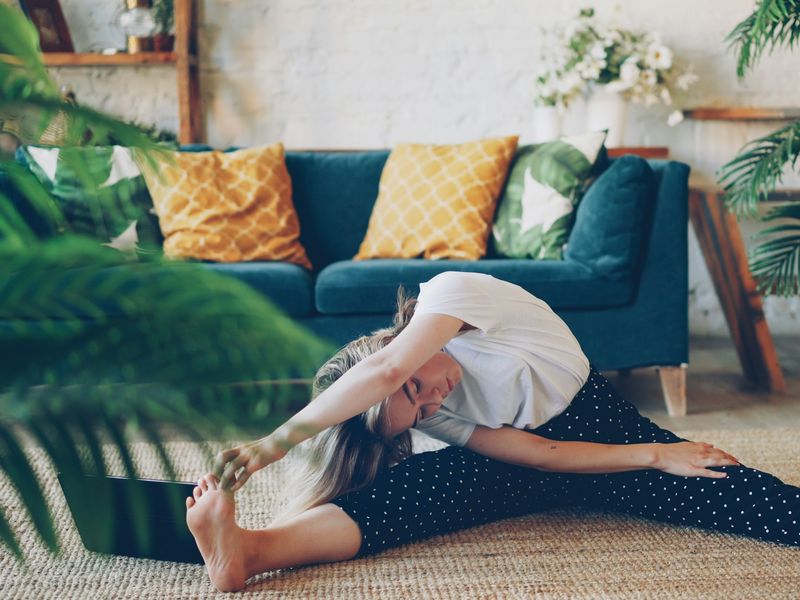 Woman stretching on her living room floor